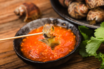 Babylonia areolata shellfish seafood on bowl ready for eat or cooked