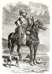 Fototapeta na wymiar Kurdish falconer. Posing horseback with his equipment and fast slim hunting dogs on a flatland. Grey tone etching style art by Duhousset, Le Tour du Monde, 1862