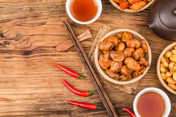 A plate of broad beans placed on a wooden board background