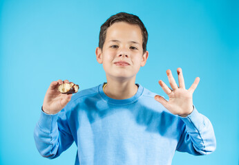 Young boy with donuts is happy about sugar snack that makes his childhood joyful and sweet