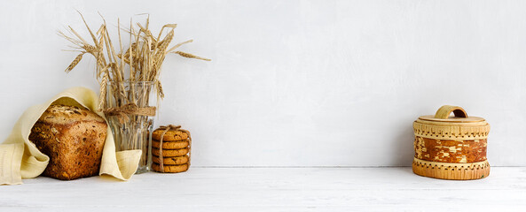 banner with a white wall background and copy space - Homemade grain bread and a linen napkin. Home...