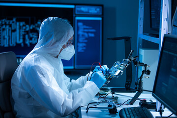 Microelectronics engineer works in a modern scientific laboratory on computing systems and...