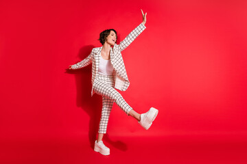 Full size photo of young happy positive good mood businesswoman enjoying free time dancing isolated on red color background
