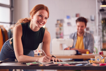 Fototapeta premium Male And Female Students Or Business Owners Working In Fashion Studio Together