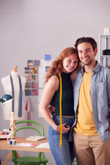 Portrait Of Male And Female Business Owners Standing Together In Fashion Studio