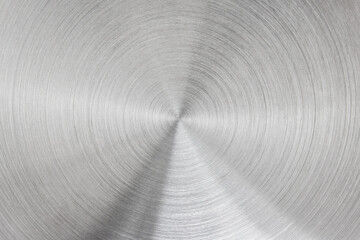 Metallic background of brushed chrome stainless steel surface with circular shapes.