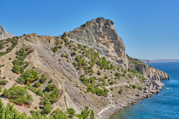 Mountain landscape, Crimean peninsula. People walk along the tourist route Golitsyn Trail. Botanical reserve New World.