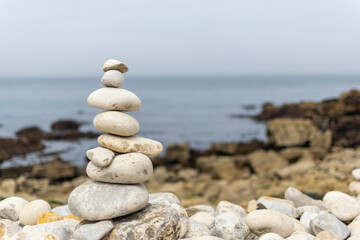 Fototapeta na wymiar Zen rocks stacked near to the ocean