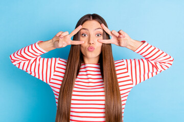 Photo of pretty cute young lady dressed striped outfit showing two v-signs cover eye sending kiss...