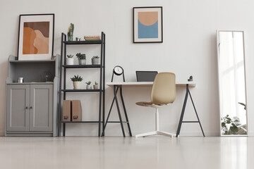 Background of minimal home office desk in modern apartment decorated by plants and abstract art,...