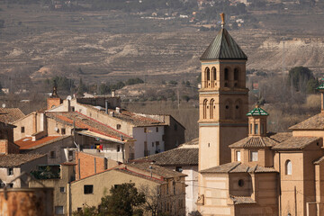 Fototapeta na wymiar Close-up of the picturesque Ainzon skyline and the surrounding rural landscape, with the Our Lady of Mercy parish church, in the Campo de Borja region, Zaragoza, Aragon, Spain.