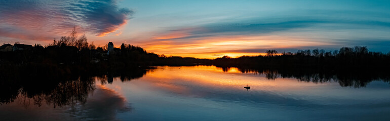 High resolution stitched panorama of a beautiful sunset with reflections near Niederpoering, Isar, Bavaria, Germany