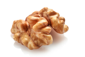 Single golden walnut kernel isolated on white