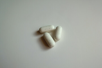 Group of three white caplets of kelp dietary supplement