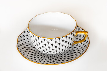 An elegant Herend porcelain tea cup with plate.
