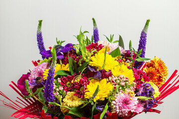 Colorful bouquet of fresh spring flowers on a light background.