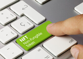 NFT Non-Fungible Token - Inscription on Green Keyboard Key.