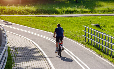 Fototapeta premium Cyclist ride on the bike path in the city Park 