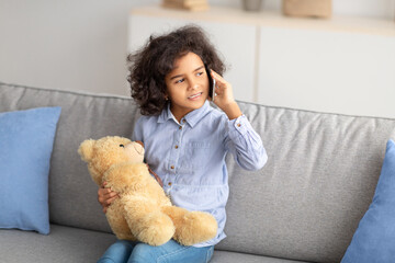 Smiling black girl talking on mobile phone