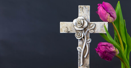 Ornate cross with tulip flowers on a black background. Condolence card. Empty place for emotional...