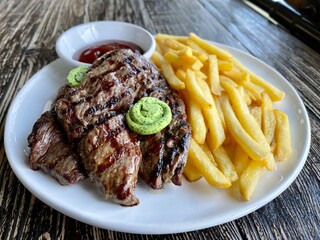 beef steak with fries and ketchup