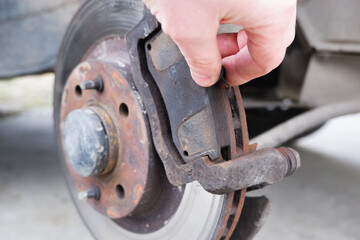 Car repair. Replacing the brake pads of disc brakes. Brake disc close-up.