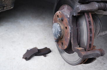 Car repair. Replacing the brake pads of disc brakes. Brake disc close-up.