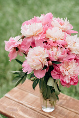 beautiful bouquet of pink peony flowers in a vase. womens day or wedding background . soft selective focus