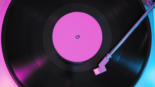 Old retro vinyl record, vintage turntable, neon light.