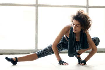 Young sporty woman is doing excercises and stretching