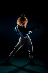 Artistic modern dancer on dark wall