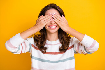 Photo of satisfied young lady toothy smile hands palms covering eyes isolated on yellow color background