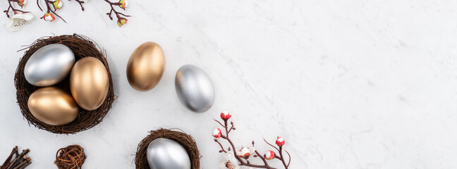 Design concept of Golden and silver Easter eggs in the nest with white plum flower.