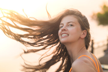 Happy vacation woman on beach summer holiday in cheerful bliss enjoying the sunshine. Beautiful girl