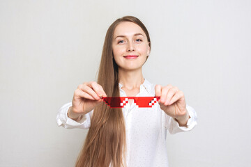 Happy young woman offers you her pixel glasses, portrait, white background, copy space