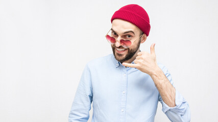 Bearded in funny glasses shows the hand gesture call me, portrait, white background, copy space, 16:9