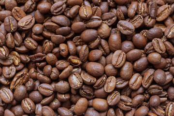 A scattering of roasted coffee beans close-up.