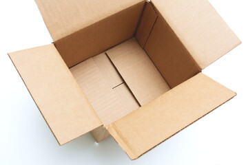 Opened empty cardboard box on a white background, cropped image, top view
