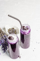 Lavender smoothie with coconut flakes and frozen blackberry