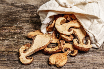 Forest dried edible mushrooms in a linen sack