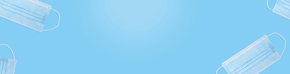 a copy space with disposable surgical mask in blue. face mask to cover the mouth and nose from contagious things such as virus and bacteria. can be used to write a warning and reminder.