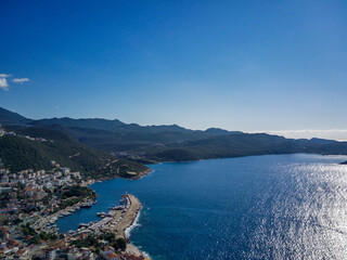 Obraz premium The top view from the drone of Kas resorts and city with amazing blue and clear lagoon and yachts in Mugla province of Turkey