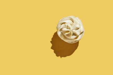 Milky cream cupcake. Birthday sweet bakery. Cookies. Yummy buttercream dessert. Wedding party food. Yellow background. Holiday recipe. Anniversary gourmet. One piece. Trendy