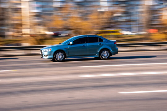 Ukraine, Kyiv - 11 March 2021: Gray Mitsubishi Lancer car moving on the street;
