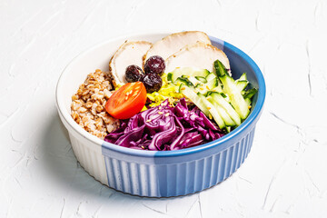 Buddha Bowl with buckwheat, baked lean pork, red cabbage, cucumber, tomato, olives, flax seeds