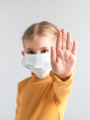 Covid-19. Coronavirus concept. Little girl child wearing mask for protection from disease and...