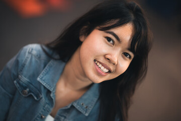 Beautiful Asian woman who has long hair travels to the festival at Yaowarat Chinatown in Thailand. Street photography of traveler woman at night.