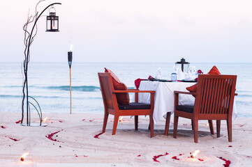 Honeymoon dinner table on island beach in Thailand