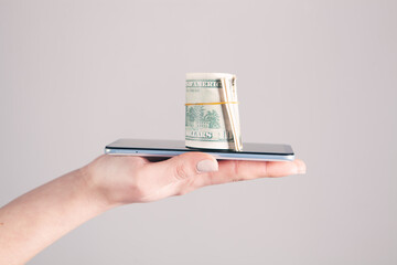 girl holding a phone and money