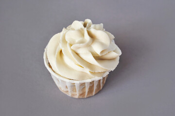 Milky cream cupcake. Birthday sweet bakery. Cookies. Yummy buttercream dessert. Wedding party food. Grey background. Holiday recipe. Anniversary gourmet. One piece